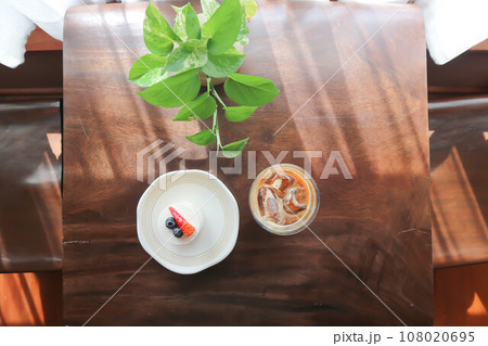 coffee, iced coffee or iced cappuccino coffee and strawberry shortcake on the table coffee, iced coffee or iced cappuccino coffee and strawberry shortcake on the table 108020695