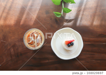 coffee, iced coffee or iced cappuccino coffee and strawberry shortcake on the table coffee, iced coffee or iced cappuccino coffee and strawberry shortcake on the table 108020697