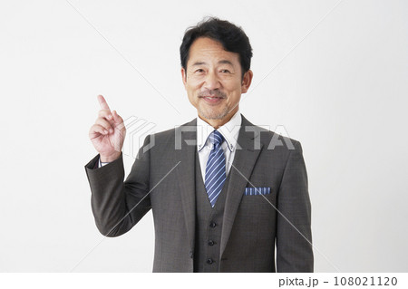左側を指差す中年のビジネスマン 白背景 左側を指差す中年のビジネスマン 白背景 108021120
