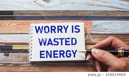 Worry is wasted energy- an inspirational quote in a notebook written in a woman's hand, Worry is wasted energy- an inspirational quote in a notebook written in a woman's hand, 108024664