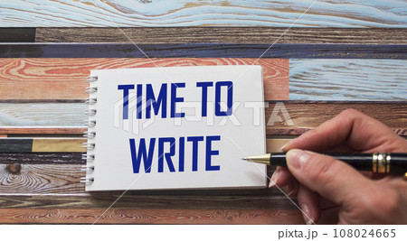 The text TIME TO WRITE is written by a female hand on a notebook. Education and business concept. The text TIME TO WRITE is written by a female hand on a notebook. Education and business concept. 108024665