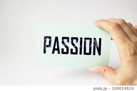 Passion words on a note in a man's hand on a light background Passion words on a note in a man's hand on a light background 108024828