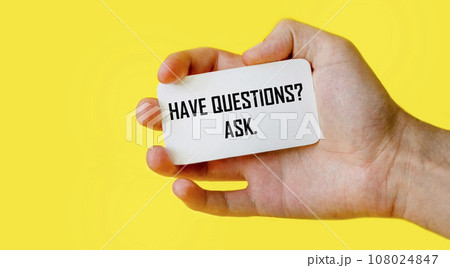 Have questions Ask. Man holding card on yellow background Have questions Ask. Man holding card on yellow background 108024847