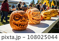 Pumpkin carving contest at a community event, showcasing creative designs. 108025044