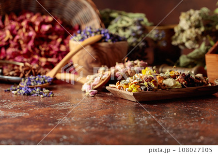Various dried medicinal plants on a brown background. Various dried medicinal plants on a brown background. 108027105