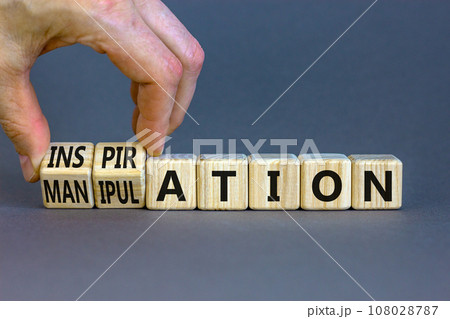 Inspiration or manipulation symbol. Concept words Inspiration and Manipulation on wooden cubes. Beautiful grey background. Psychologist hand. Psychology inspiration manipulation concept. Copy space. 108028787