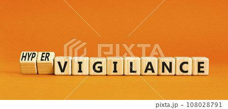 Vigilance or hypervigilance symbol. Concept words Vigilance Hypervigilance on wooden blocks. Beautiful orange table orange background. Psychology vigilance hypervigilance concept. Copy space. 108028791