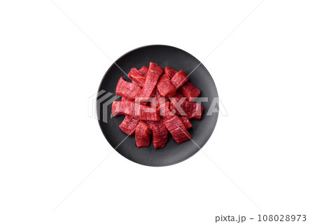 Fresh juicy raw beef slices with salt and spices 108028973