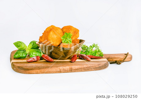 Breaded Chicken nuggets Fillet with salad on a White Background,food at home. Fast homemade food.Chicken breaded schnitzels. Breaded Chicken Inner Fillet, Chicken Breaded Raw Meat. Fast cooking. 108029250