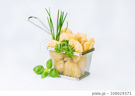 Breaded chicken nuggets. Breaded Chicken Inner Fillet with green lettuce leaves on a White Background,Chicken Breaded Raw Meat,Fillet.Fast homemade food at home.Chicken breaded schnitzels.Fast cooking 108029371