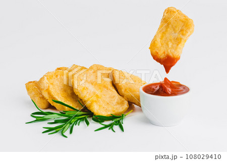 Levitation, breaded chicken nuggets, semi-finished product with fresh herbs on a white background. Fast food. Quick cooking at home. Copy space. 108029410