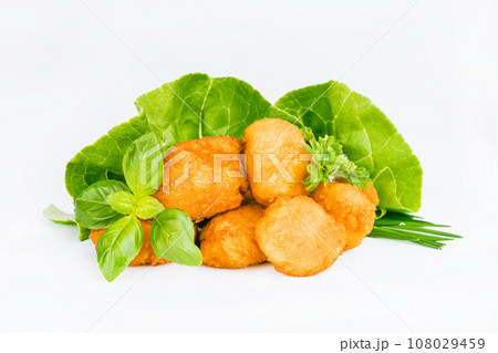 Breaded Chicken Inner Fillet with green lettuce leaves on a White Background,Chicken Breaded Raw Meat,Fillet.Breaded chicken nuggets. Fast homemade food at home.Chicken breaded schnitzels.Fast cooking Breaded Chicken Inner Fillet with green lettuce leaves on a White Background,Chicken Breaded Raw Meat,Fillet.Breaded chicken nuggets. Fast homemade food at home.Chicken breaded schnitzels.Fast cooking 108029459