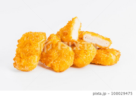 Chicken Breaded Fillet. Breaded chicken nuggets. Fast homemade food at home. Chicken breaded schnitzels. Breaded Chicken Inner Fillet on a White Background,Chicken Breaded Raw Meat. Fast cooking. 108029475
