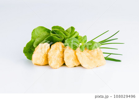 Breaded Chicken Inner Fillet with green lettuce leaves on a White Background,Chicken Breaded Raw Meat,Fillet.Breaded chicken nuggets. Fast homemade food at home.Chicken breaded schnitzels.Fast cooking 108029496