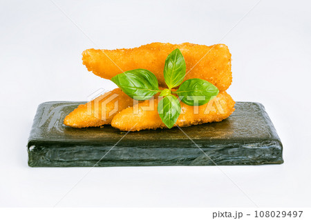 Chicken Breaded Fillet. Breaded chicken nuggets. Fast homemade food at home. Chicken breaded schnitzels. Breaded Chicken Inner Fillet on a White Background,Chicken Breaded Raw Meat. Fast cooking. 108029497