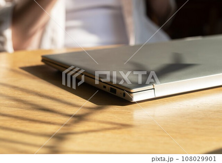 Closed laptop on wooden desk. Finished end done work Closed laptop on wooden desk. Finished end done work 108029901