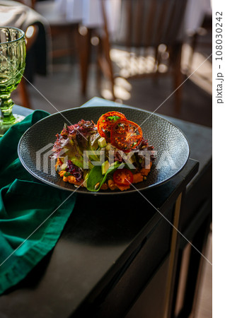 Vegetarian salad with avocado, basil, lettuce and cherry tomatoes isolated 108030242