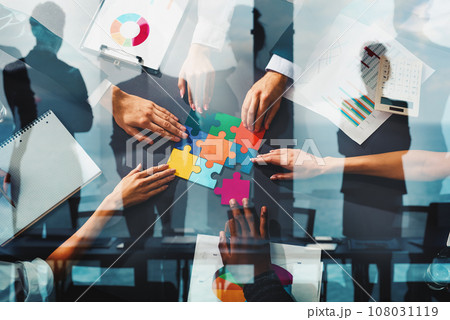Businessmen working together to build a puzzle as teamwork, partnership and integration concept 108031119