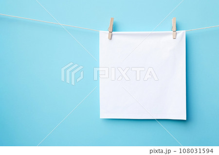 Note paper hanging with clothespins. White paper hung on laundry line, mockup, empty paper cards Note paper hanging with clothespins. White paper hung on laundry line, mockup, empty paper cards 108031594