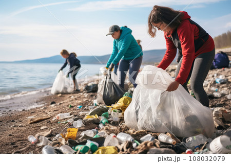 Group of volunteers helping to keep nature clean by collecting garbage into plastic bag Group of volunteers helping to keep nature clean by collecting garbage into plastic bag 108032079