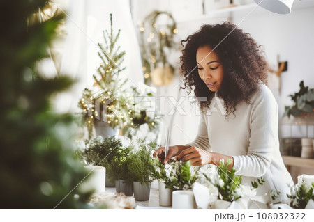African American woman florist creating Christmas decor in flower shop. Small business 108032322