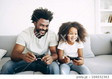 African American Father and daughter playing fun online games while spending time together at home African American Father and daughter playing fun online games while spending time together at home 108032363