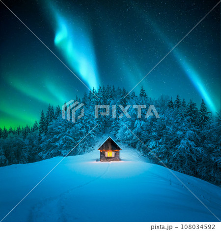 A winter scene with a solitary wooden cabin 108034592
