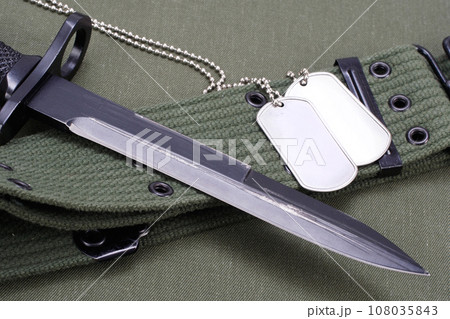 M16 rifle bayonet on uniform background M16 rifle bayonet on uniform background 108035843