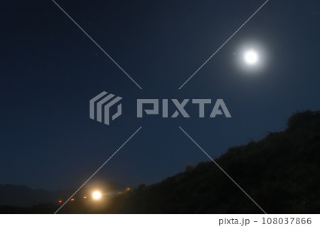 北杜市小淵沢町、夜明け前、小海線築堤の上に十六夜の月、小淵沢駅発回送下り列車 108037866