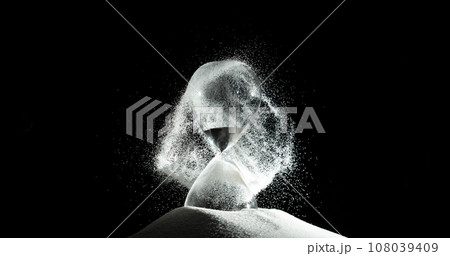 Hourglass add more sand of time on white sand over black background. White hourglass show more time Deadline extended time management hope concept hour glass, life clock passing by Hourglass add more sand of time on white sand over black background. White hourglass show more time Deadline extended time management hope concept hour glass, life clock passing by 108039409