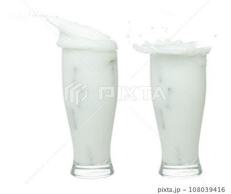 Daily Milk white lotion droplet fly splashing. Milk cream pour spill float out of tall glass. Moisturizer lotion explosion spill. White background isolated high speed shutter freeze 108039416