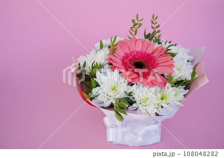 A beautiful bright bouquet of blooming fresh gerberas for a gift collected by an experienced florist 108048282