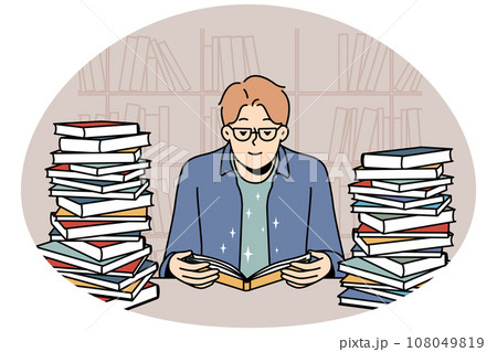 Young man with book pile reading and studying 108049819