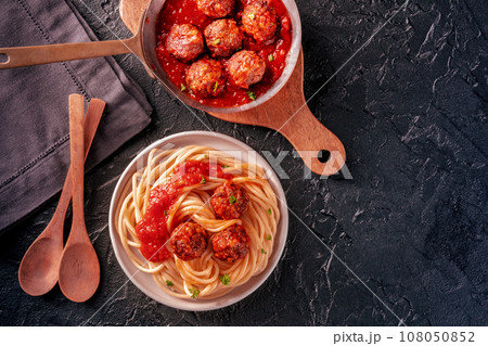 Meatballs. Beef meat balls, overhead flat lay shot in a pan and with spaghetti Meatballs. Beef meat balls, overhead flat lay shot in a pan and with spaghetti 108050852