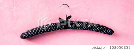 Fashion collection panorama. Black satin hanger for delicate clothes Fashion collection panorama. Black satin hanger for delicate clothes 108050853