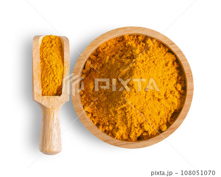 Turmeric powder pile in wood bowl and scoop isolated on white Turmeric powder pile in wood bowl and scoop isolated on white 108051070