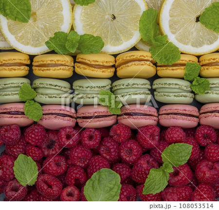 macaroons of different colors with with raspberries, lemon and mint macaroons of different colors with with raspberries, lemon and mint 108053514