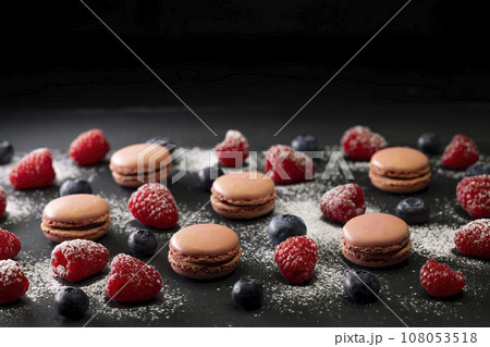 macaroons of different colors on a black background macaroons of different colors on a black background 108053518