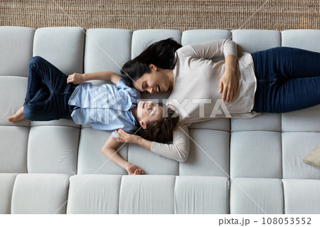 Top view laughing Asian mother with son lying on couch 108053552
