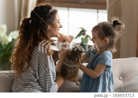 Loving young mother play puppet theater with little daughter Loving young mother play puppet theater with little daughter 108053713