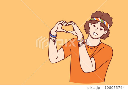 Hippie man demonstrates heart gesture made from fingers and calling for pacifism 108053744