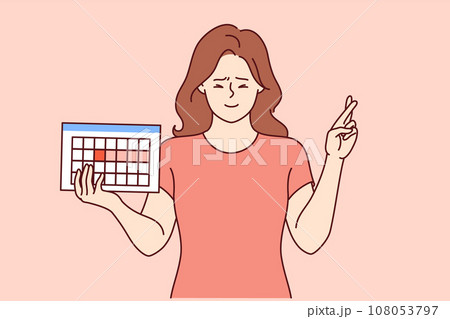 Female hormonal calendar in hands of girl crossing fingers in hope of successfully conceiving child Female hormonal calendar in hands of girl crossing fingers in hope of successfully conceiving child 108053797