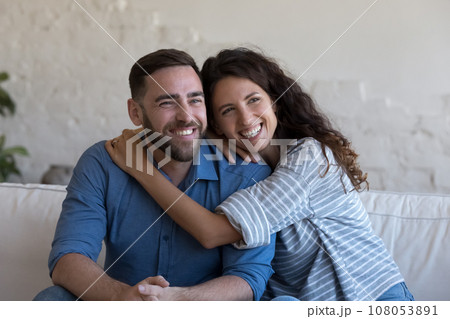 Cheerful attractive couple in love hugging with affection Cheerful attractive couple in love hugging with affection 108053891