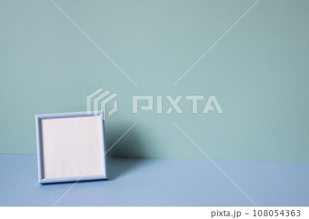 Blank picture frame on mint blue background. copy space 108054363