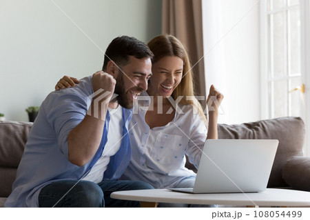 Excited overjoyed couple winning money prize, getting happy notice Excited overjoyed couple winning money prize, getting happy notice 108054499