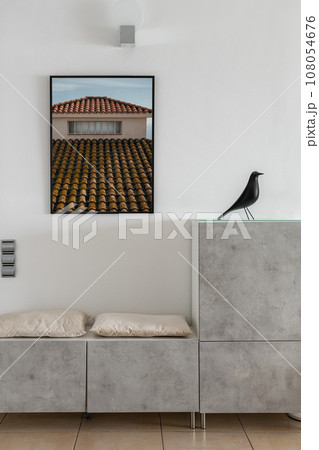 Bench with pillows and storage under picture in entryway 108054676