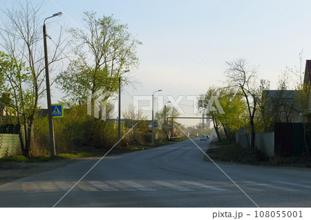Evening landscape with a road on which cars are driving Evening landscape with a road on which cars are driving 108055001