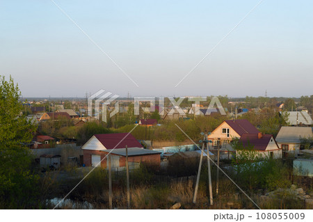 Evening landscape with village houses at sunset Evening landscape with village houses at sunset 108055009
