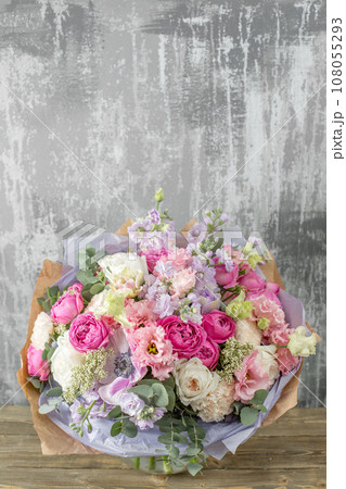 Small Beautiful bouquet of mixed flowers in woman hand. Floral shop concept . Beautiful fresh cut bouquet. Flowers delivery Small Beautiful bouquet of mixed flowers in woman hand. Floral shop concept . Beautiful fresh cut bouquet. Flowers delivery 108055293