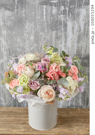 Small Beautiful bouquet of mixed flowers in woman hand. Floral shop concept . Beautiful fresh cut bouquet. Flowers delivery 108055294